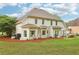 Spacious backyard with a white siding home, green grass, mature trees, and a wood fence is perfect for outdoor activities at 3874 Lost Oak Dr, Buford, GA 30519