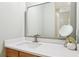 Bathroom with a modern vanity, framed mirror, and decorative elements, creating a clean aesthetic at 3874 Lost Oak Dr, Buford, GA 30519