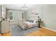 Bedroom boasting hardwood floors and modern decorations and light fixture at 3874 Lost Oak Dr, Buford, GA 30519