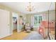 Bright, charming bedroom with hardwood floors, a chandelier, and a playful tent, creating a cozy space at 3874 Lost Oak Dr, Buford, GA 30519