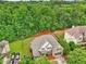 A beautiful home with mature landscaping, a two-car garage, and a wooded area in the background at 3874 Lost Oak Dr, Buford, GA 30519