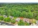 A serene neighborhood featuring beautiful homes with lush greenery and mature trees at 3874 Lost Oak Dr, Buford, GA 30519