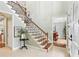 Welcoming foyer with staircase, hardwood floors, and natural light entering through the front door at 3874 Lost Oak Dr, Buford, GA 30519