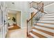 Bright foyer features hardwood stairs, black iron railing, tile floor and an airy feel at 3874 Lost Oak Dr, Buford, GA 30519