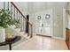 Bright foyer with tile floors, staircase, light green walls and a frosted glass front door at 3874 Lost Oak Dr, Buford, GA 30519