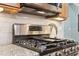 Close up shot of stainless steel oven range with granite counter and tile backsplash at 3874 Lost Oak Dr, Buford, GA 30519
