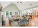 Open concept living room and dining area with hardwood floors, fireplace, and bright lighting at 3874 Lost Oak Dr, Buford, GA 30519