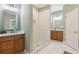 Elegant main bathroom with dual vanities, walk-in shower, and marble floors at 3874 Lost Oak Dr, Buford, GA 30519