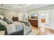 Large main bedroom features wood floors, a tray ceiling, and an open doorway to the main bathroom at 3874 Lost Oak Dr, Buford, GA 30519