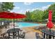 Community pool area featuring lounge chairs, umbrellas, and ample space for relaxation at 3874 Lost Oak Dr, Buford, GA 30519