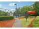 Community tennis court with well-maintained fencing, seating, and a shade structure at 3874 Lost Oak Dr, Buford, GA 30519