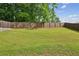 Expansive backyard showcasing a well-maintained lawn and privacy fence, perfect for outdoor activities at 5320 Flat Rock Pt, Lithonia, GA 30038