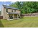 Spacious backyard featuring a lush lawn and a covered patio perfect for outdoor entertaining at 5320 Flat Rock Pt, Lithonia, GA 30038