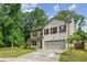 Inviting two-story home boasts a well-manicured lawn and attached two-car garage at 5320 Flat Rock Pt, Lithonia, GA 30038