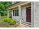 Close-up of a home's front entrance with a stylish door and well-kept landscaping at 5320 Flat Rock Pt, Lithonia, GA 30038