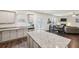 Spacious kitchen with granite countertops and stainless steel appliances is open to dining area at 5320 Flat Rock Pt, Lithonia, GA 30038