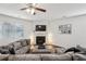 Inviting living room features a fireplace, ceiling fan, and a comfortable sectional sofa at 5320 Flat Rock Pt, Lithonia, GA 30038