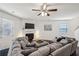 Comfortable living room features a fireplace, ceiling fan, and a large sectional sofa at 5320 Flat Rock Pt, Lithonia, GA 30038