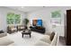 Bright living room with neutral walls, plush seating, and a view to the backyard at 5320 Flat Rock Pt, Lithonia, GA 30038