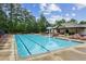 A sparkling swimming pool with chairs, umbrellas and clubhouse offer hours of summer fun for residents at 5320 Flat Rock Pt, Lithonia, GA 30038