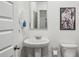 White powder room features pedestal sink and crisp bright white paint at 5320 Flat Rock Pt, Lithonia, GA 30038