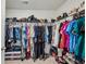 Organized walk-in closet features ample storage on multiple shelves and hanging rods at 5320 Flat Rock Pt, Lithonia, GA 30038
