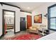 Well-lit bedroom featuring a red area rug, comfortable chair, and stylish dark trim at 791 Wylie Se St # 807, Atlanta, GA 30316