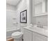 Bright bathroom featuring a shower and tub combo, framed mirror, and classic white fixtures at 10 Rockmart Nw Dr, Atlanta, GA 30314