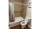 Bathroom featuring a shower-tub combination with tiled walls and a white toilet at 10 Rockmart Nw Dr, Atlanta, GA 30314