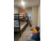 Cozy bedroom with bunk bed and a gray sofa and accent pillows at 10 Rockmart Nw Dr, Atlanta, GA 30314