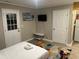 Well-lit bedroom with a bed, modern rug, and mounted TV, adjacent to a functional kitchenette at 10 Rockmart Nw Dr, Atlanta, GA 30314