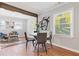 Bright dining room featuring a round table with seating and an open view into the adjacent living room space at 10 Rockmart Nw Dr, Atlanta, GA 30314