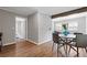 Open dining area with a round table and hardwood floors, adjacent to a well-lit living space at 10 Rockmart Nw Dr, Atlanta, GA 30314