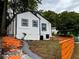 Charming home with white siding, blue trim, freshly painted with a landscaped yard and vibrant walkway at 10 Rockmart Nw Dr, Atlanta, GA 30314