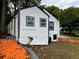 Charming home with white siding, blue trim, freshly painted with a landscaped yard and vibrant walkway at 10 Rockmart Nw Dr, Atlanta, GA 30314