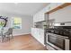 Modern kitchen featuring stainless steel appliances, sleek cabinetry, and a well-lit dining area at 10 Rockmart Nw Dr, Atlanta, GA 30314