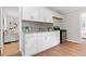 Updated kitchen with white cabinetry, stainless steel appliances, and seamless access to the living spaces at 10 Rockmart Nw Dr, Atlanta, GA 30314