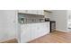Kitchen featuring white cabinets, granite countertops, stainless steel backsplash, and modern appliances at 10 Rockmart Nw Dr, Atlanta, GA 30314