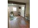 Modern living room with hardwood floors, a comfortable chair, and a view of the entrance at 10 Rockmart Nw Dr, Atlanta, GA 30314