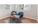 Bright sitting area with Zebra print rug and two matching blue cushioned chairs at 10 Rockmart Nw Dr, Atlanta, GA 30314