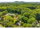 Aerial view of a home surrounded by lush greenery and mature trees, close to a mountain in the background at 1150 Kennesaw Due West Nw Rd, Kennesaw, GA 30152