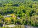 Aerial view of a home surrounded by lush greenery and mature trees, near a road at 1150 Kennesaw Due West Nw Rd, Kennesaw, GA 30152