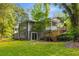 The back of the home features a deck, staircase, and large windows, seamlessly integrating indoor and outdoor living at 1150 Kennesaw Due West Nw Rd, Kennesaw, GA 30152