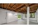 Unfinished basement with concrete floor, exposed beams, and access to the backyard at 1150 Kennesaw Due West Nw Rd, Kennesaw, GA 30152