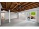 Open basement space featuring painted white walls and a sliding door to the backyard at 1150 Kennesaw Due West Nw Rd, Kennesaw, GA 30152