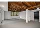 Unfinished basement features exposed wood ceiling, white painted walls, and a window at 1150 Kennesaw Due West Nw Rd, Kennesaw, GA 30152