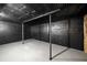 Unfinished basement with exposed beams and painted black walls at 1150 Kennesaw Due West Nw Rd, Kennesaw, GA 30152