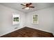 Bright bedroom featuring hardwood floors, ceiling fan, and white trim at 1150 Kennesaw Due West Nw Rd, Kennesaw, GA 30152