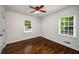 Bedroom filled with natural light, thanks to two windows, and a ceiling fan at 1150 Kennesaw Due West Nw Rd, Kennesaw, GA 30152