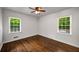 Inviting bedroom features natural light, hardwood floors, and a ceiling fan at 1150 Kennesaw Due West Nw Rd, Kennesaw, GA 30152